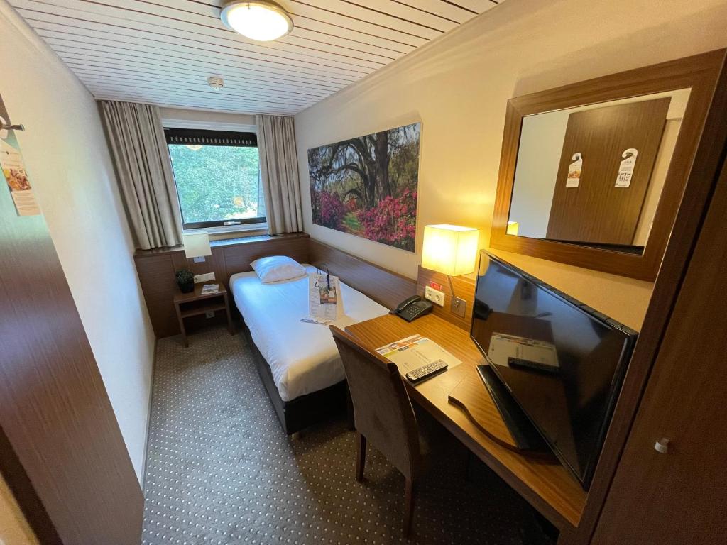 Postel nebo postele na pokoji v ubytování Fletcher Hotel-Restaurant Wolfheze