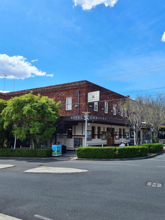 a brick building with a clock on top of it at Hotel Concord in Sydney