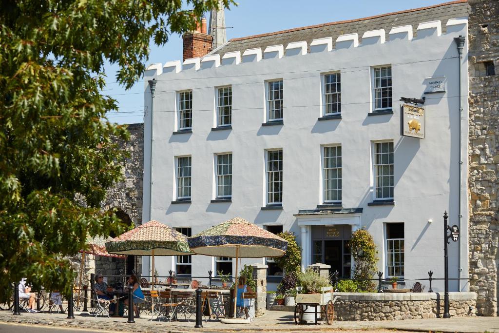 a white building with two umbrellas in front of it at THE PIG-in the wall in Southampton