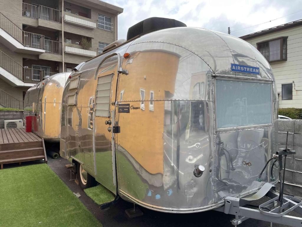 an old train car parked in front of a building at TOCORO. Mt.Fuji The Airstream Kawaguchiko Station in Azagawa