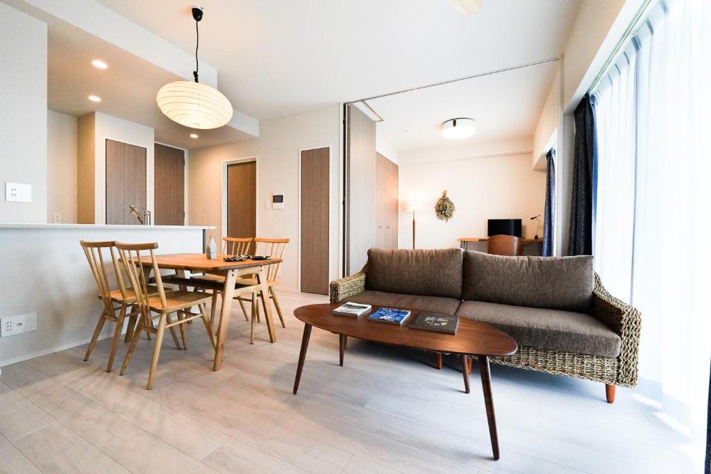 a living room with a couch and a table at Branchera Naha 1107 in Naha