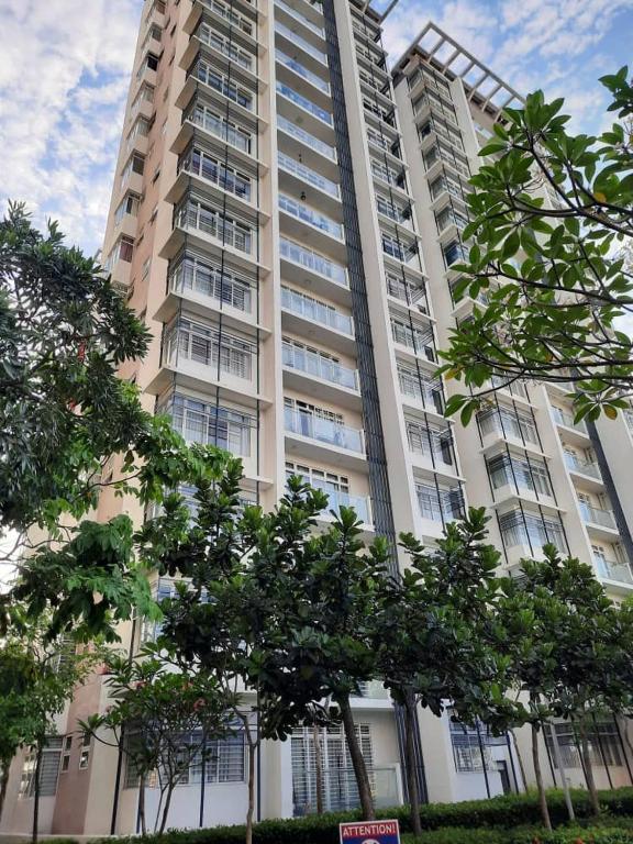 a tall building with trees in front of it at Dwiputra GetAway Homestay in Putrajaya