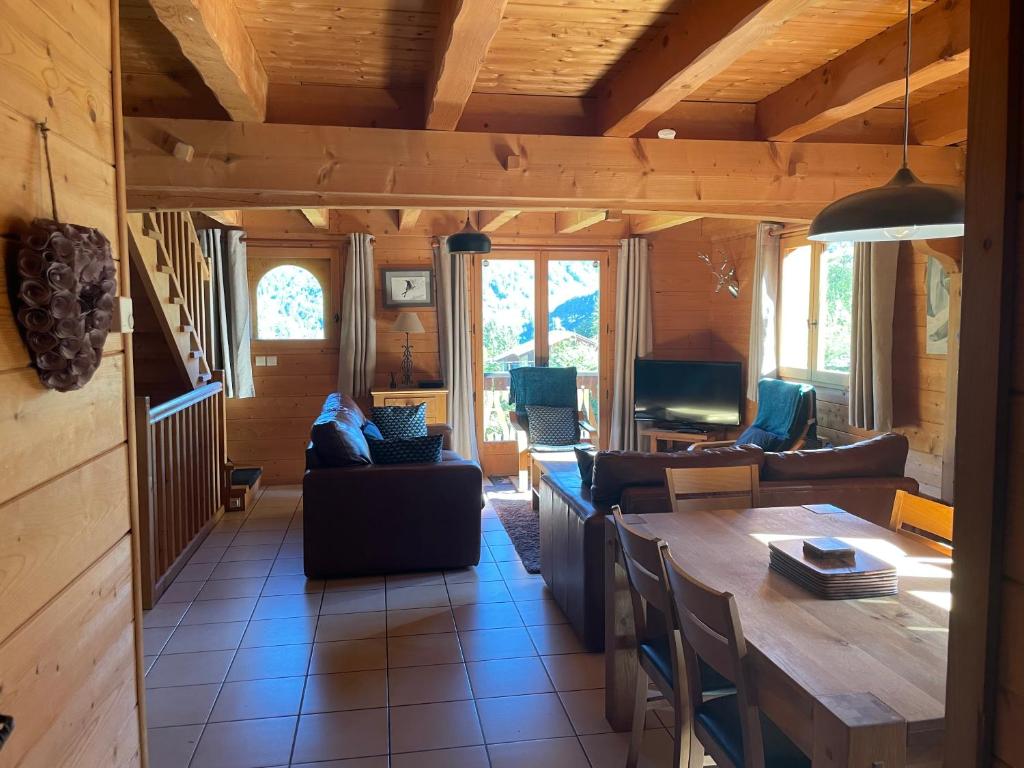 a living room with a couch and a table at Chalet Olimon in Saint-Jean-dʼAulps