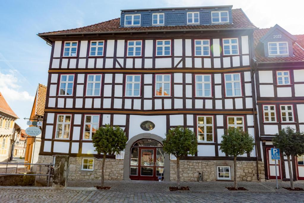 a large building with a red door at Hotel & Restaurant Brauner Hirsch Osterwieck in Osterwieck