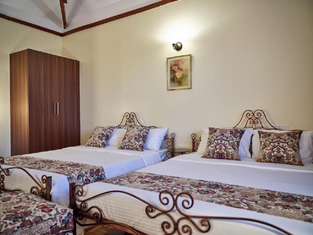 Postel nebo postele na pokoji v ubytování The Drexel House Kenya
