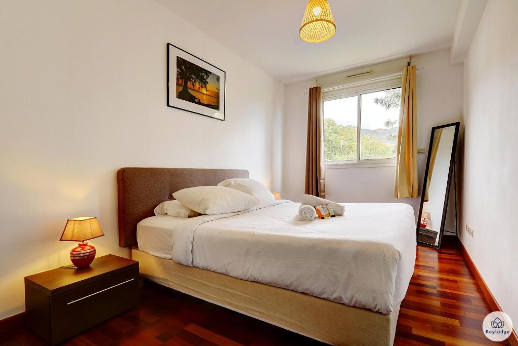 En eller flere senge i et værelse på La Corbeilloise - T2 de 50m2 à Saint-Denis