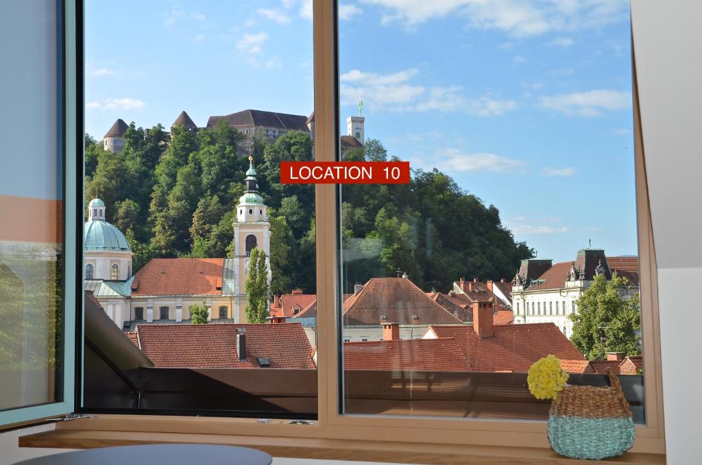 a view of a city from a window with a town at i Design Apartment in Ljubljana