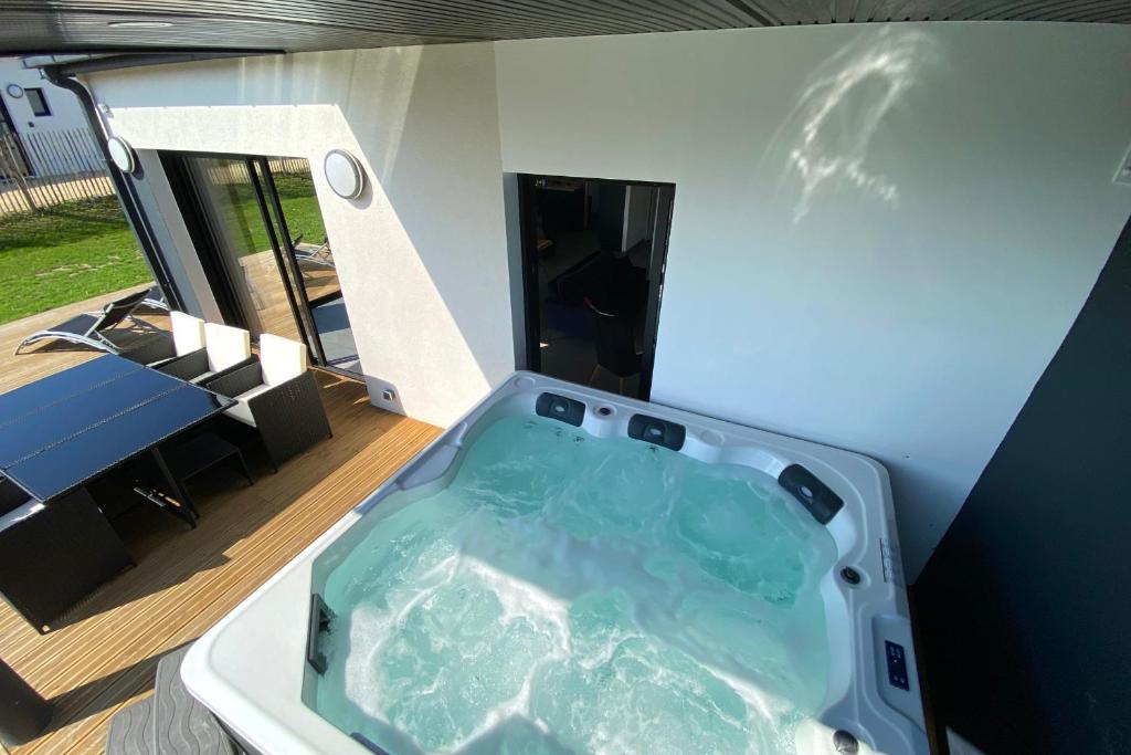 a bath tub in the middle of a room at carantec 4 stars villa with jacuzzi and garden for 8 persons in Carantec
