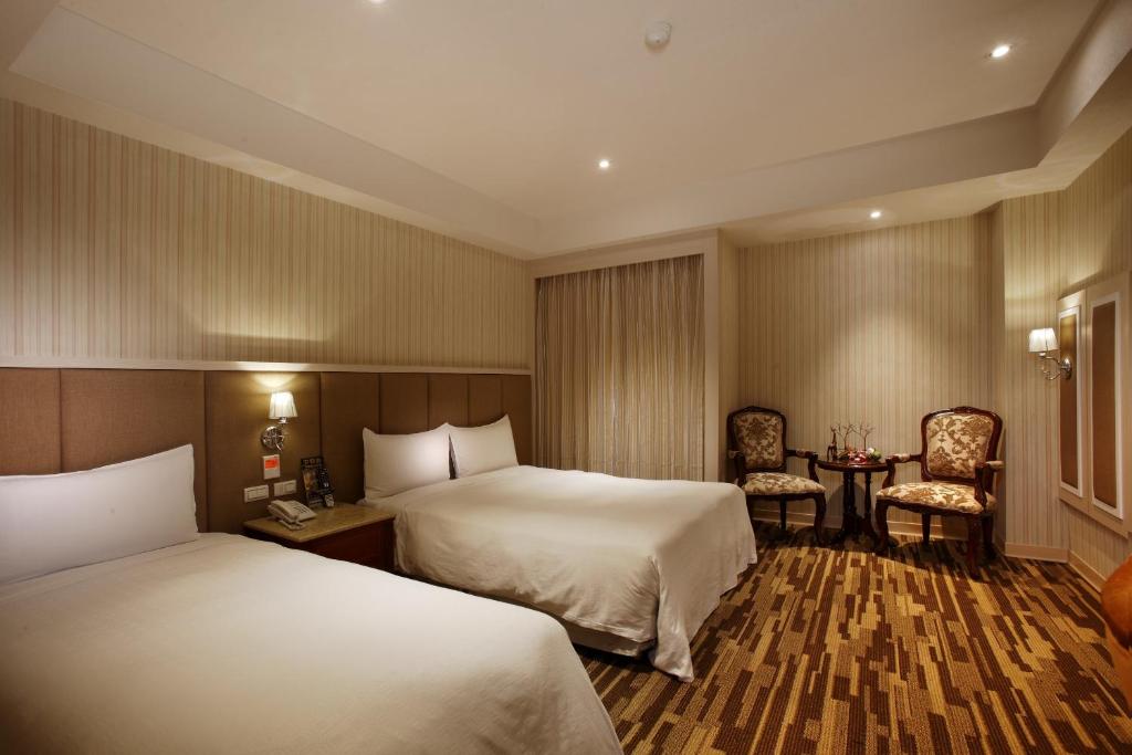 Postel nebo postele na pokoji v ubytování Grace Hotel