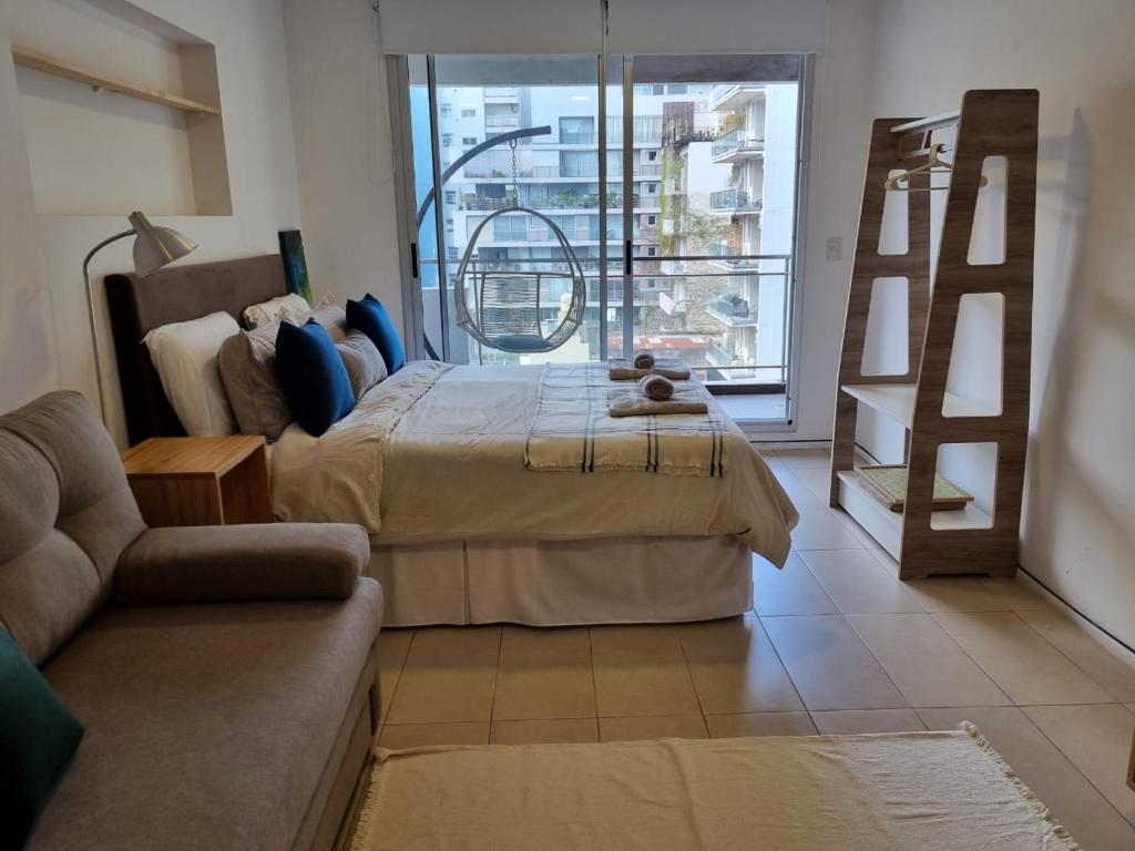 a living room with a bed and a couch at Dorrego 1829 Studio in Buenos Aires