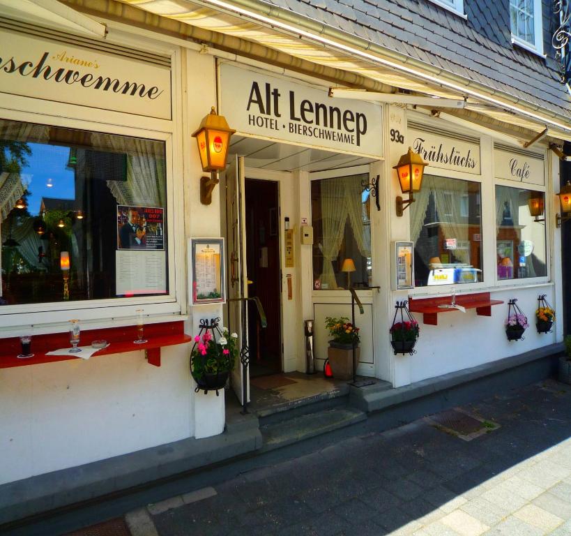 a store front of a building with flowers in the windows at Hotel Alt-Lennep in Remscheid