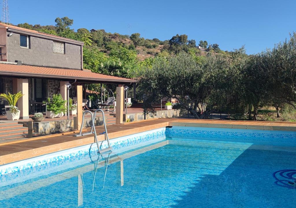 a swimming pool in front of a house at Peri Peri Etna Guest House in Montargano