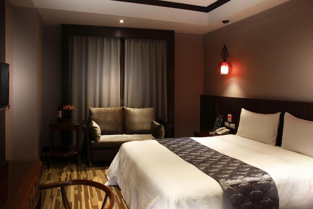 Postel nebo postele na pokoji v ubytování Grace Hotel