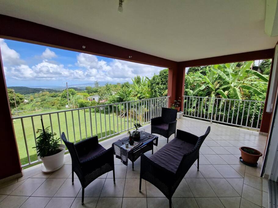 a balcony with a table and chairs and a view at RELAX superbe appartement avec vue imprenable in Bois la Charles