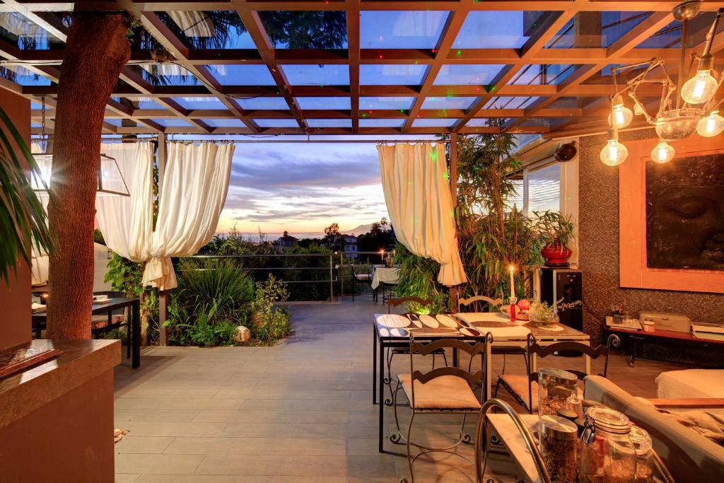 a patio with tables and chairs in a restaurant at Marbella Boutique Art suites in Marbella
