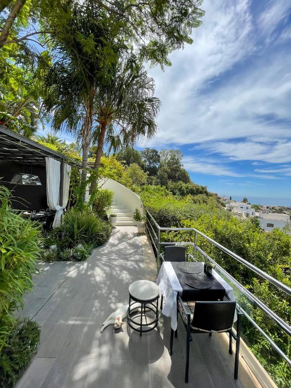 a balcony with a table and chairs and trees at Marbella Boutique Art suites in Marbella