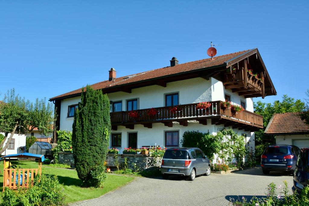 a house with cars parked in front of it at Ferienwohnung am Chiemsee in Übersee