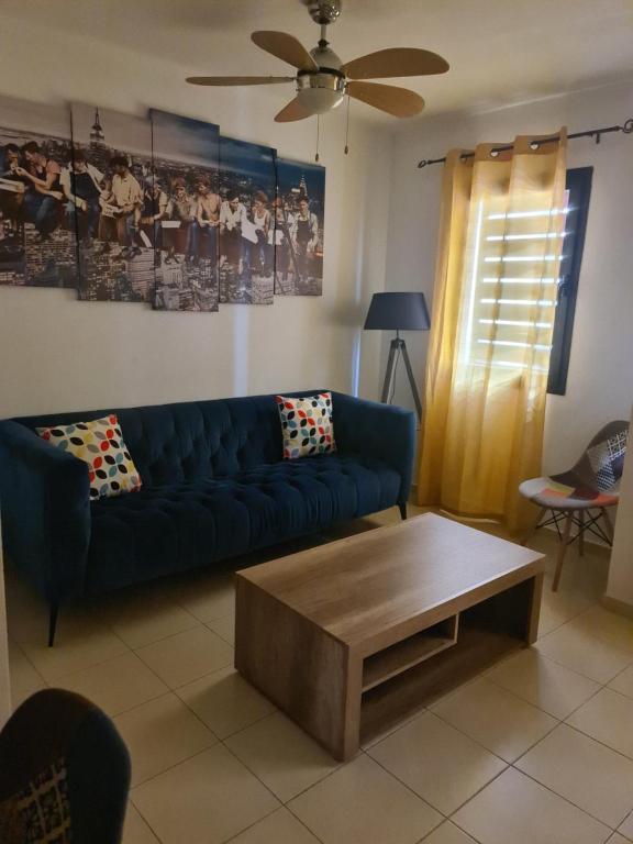 a living room with a blue couch and a coffee table at Las Brisas in Granadilla de Abona