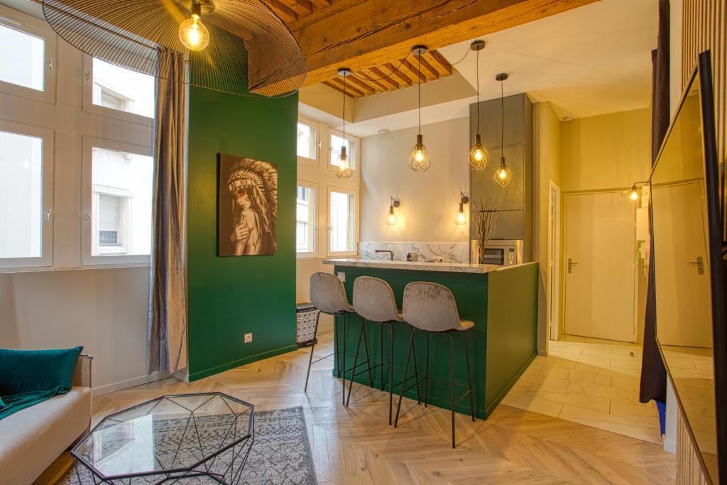a kitchen with a green island in a room at Superbe appartement presqu'île in Lyon