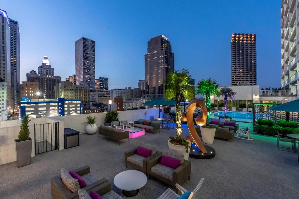 a rooftop patio with furniture and a city skyline at Holiday Inn New Orleans-Downtown Superdome, an IHG Hotel in New Orleans