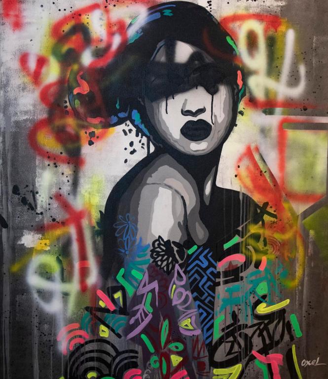 a painting of a woman on a wall with graffiti at Hotel Philosophy in Amman