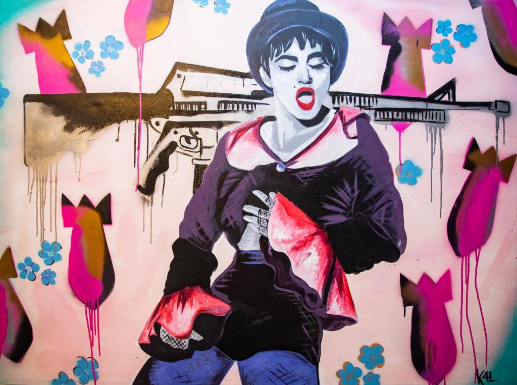 a painting of a woman with a gun at Hotel Philosophy in Amman