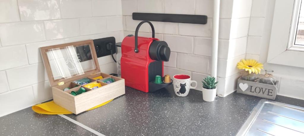 a kitchen with a counter with a suitcase and a box at *Street Clichy Art* - Appartement à 200 m de Paris ! in Clichy