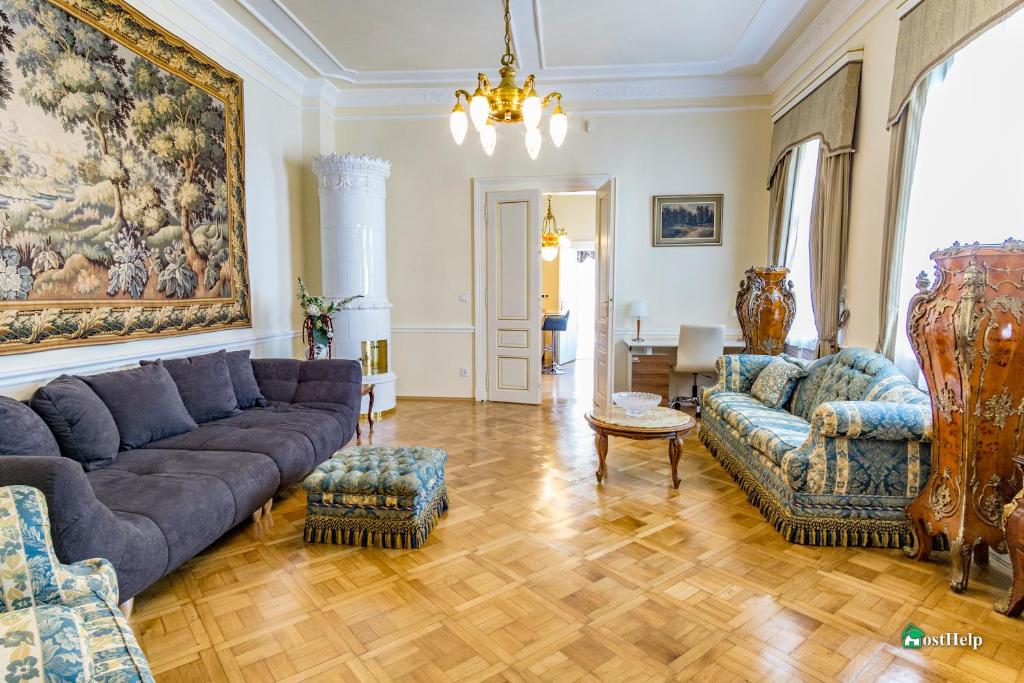 a living room with couches and a painting on the wall at Unique location with garden and terrace Old Town in Prague