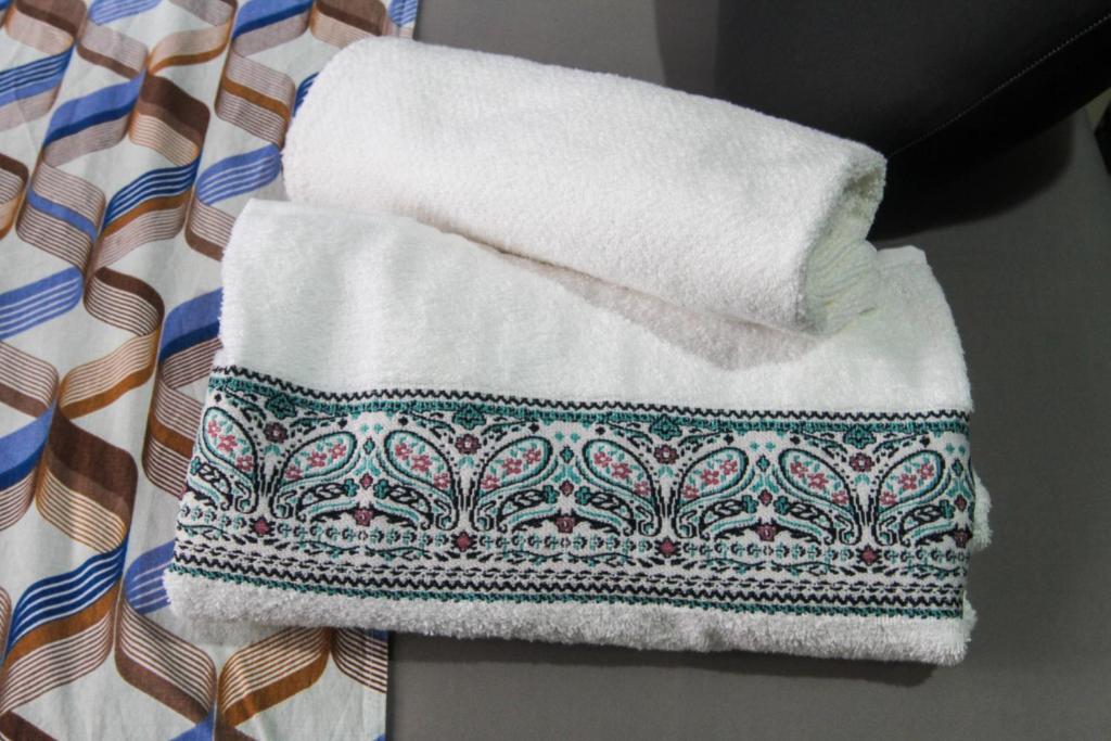 a pile of towels sitting on top of a table at Studio no Largo da Carioca - Rio de Janeiro in Rio de Janeiro