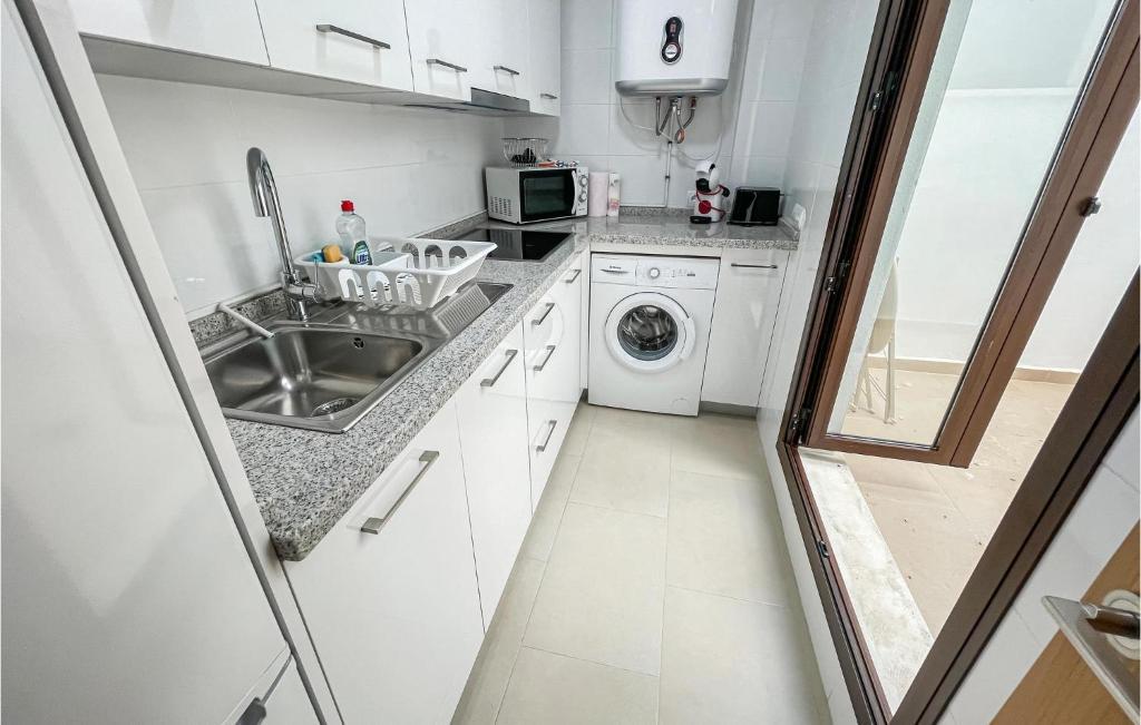 A kitchen or kitchenette at Cozy Apartment In Estepona With Wifi