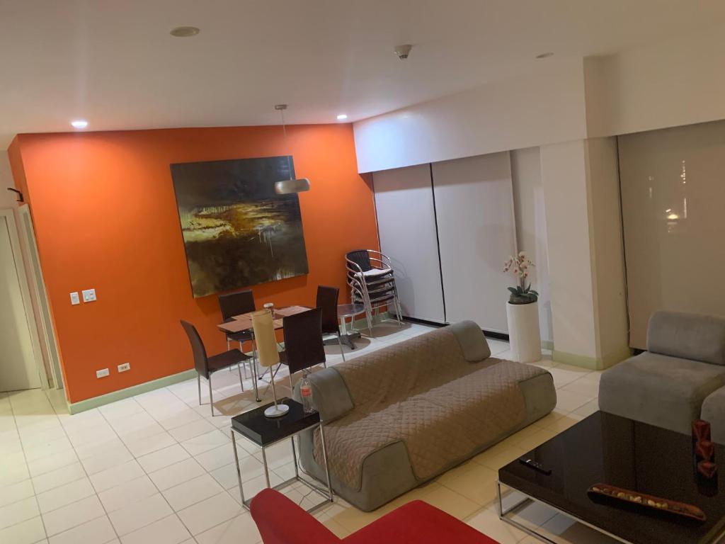a living room with a couch and a table at JACO BAY in Jacó
