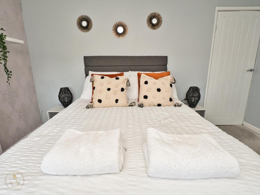 a white bed with two pillows and two mirrors on the wall at B43 Great Location Near Bhm City-Free Parking- Free WiFi- Near Villa Park in Holly Lane