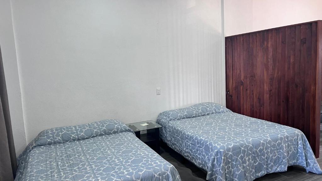 Pérula的住宿－Bungalows del Mar En Punta Perula- Casa Tory，一间客房内配有两张床的房间