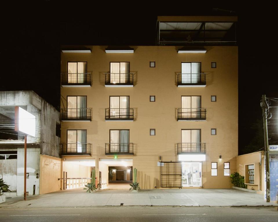 a tall building with balconies on the side of it at Hotel Guivá Aeropuerto in Oaxaca City
