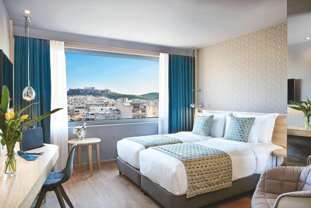 Postel nebo postele na pokoji v ubytování Wyndham Grand Athens
