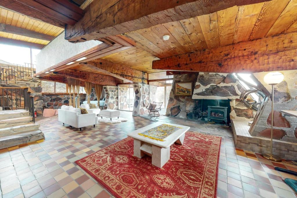 a large living room with a stone wall at Stone Temple in Yucca Valley