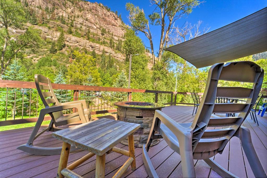 two chairs and a table on a deck at Updated Mtn Home with Deck on Uncompahgre River in Ouray