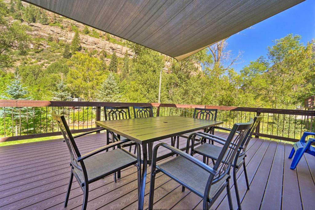 a wooden table and chairs on a deck at Updated Mtn Home with Deck on Uncompahgre River in Ouray