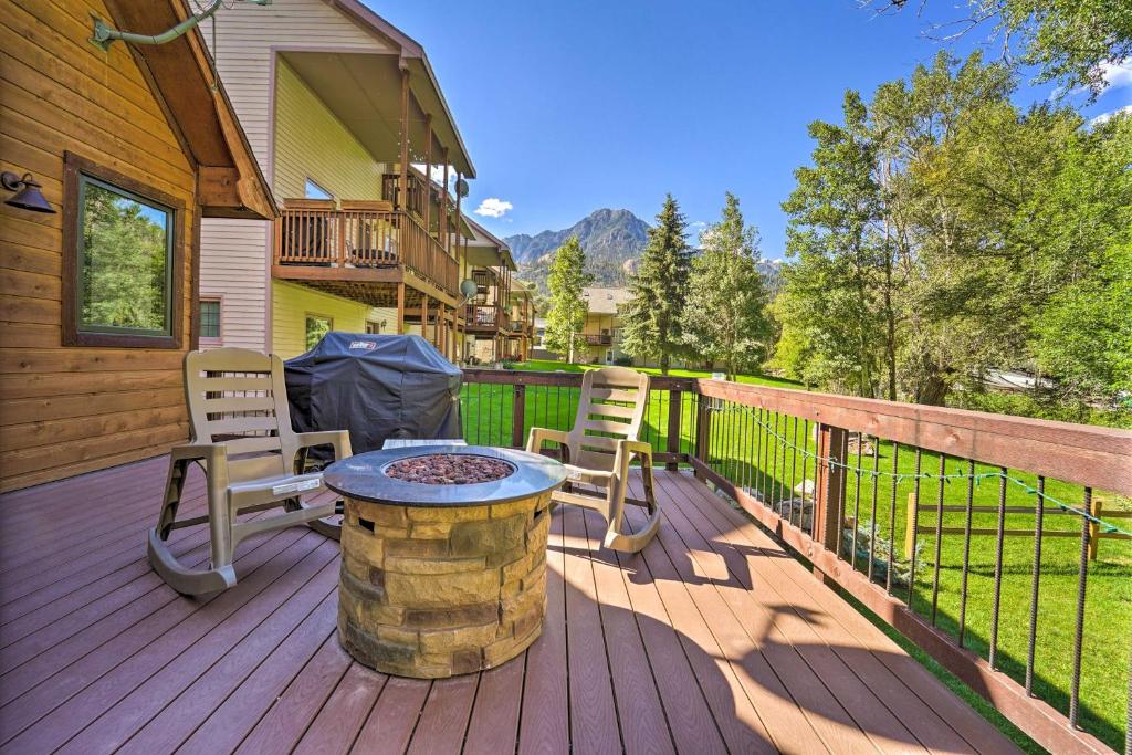 a deck with chairs and a table on a house at Updated Mtn Home with Deck on Uncompahgre River in Ouray