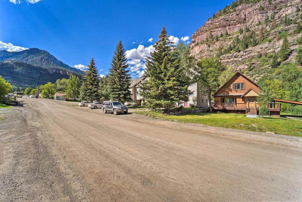 a dirt road with a house and a mountain at Updated Mtn Home with Deck on Uncompahgre River in Ouray
