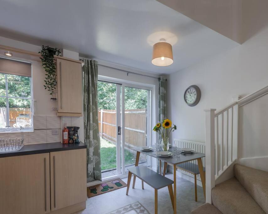 a kitchen and living room with a table and a window at Chapel Break, 2 Bed, 2 Bathroom House With Parking & Fast Wifi in Norwich