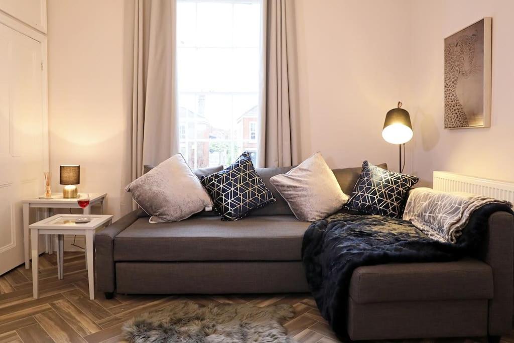 a living room with a couch with pillows on it at Yoxford House, Ginger & Gold Ltd in Norwich