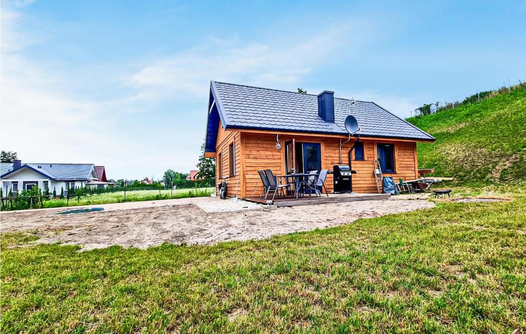 a log cabin with a patio in a field at 2 Bedroom Beautiful Home In Gizycko in Giżycko