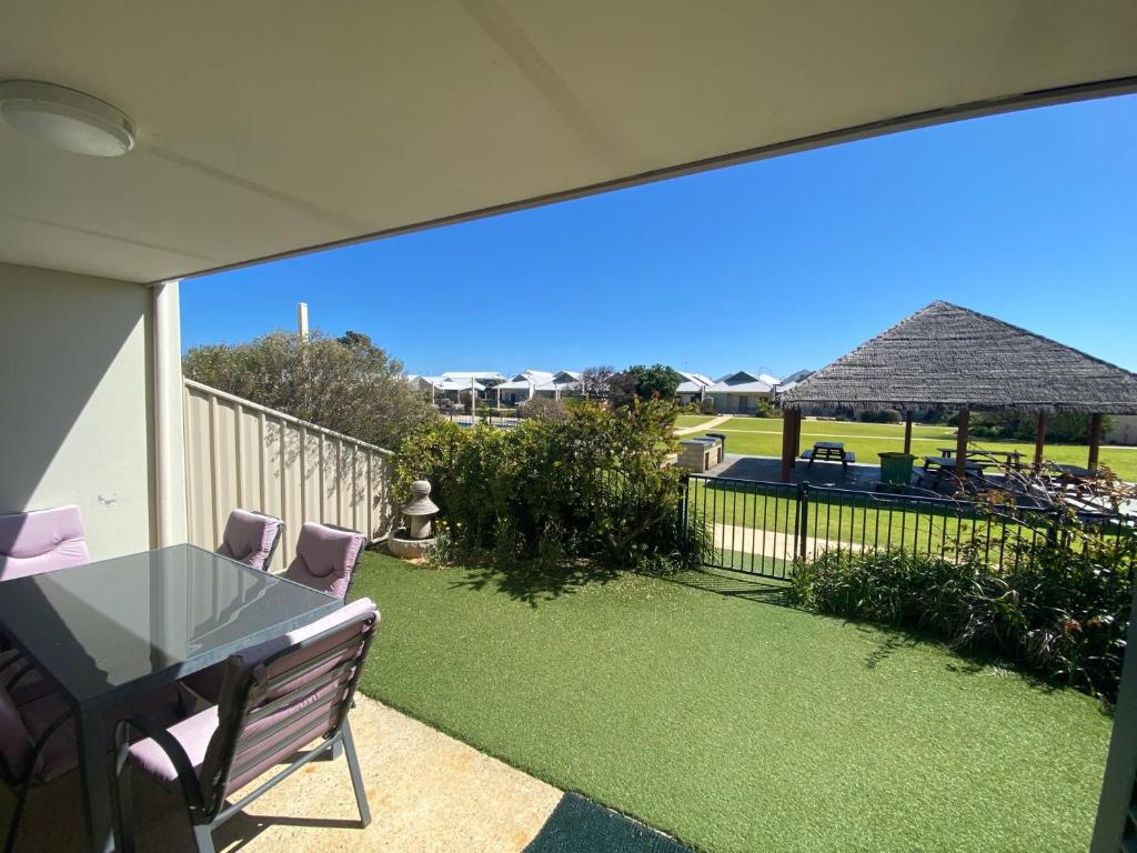 a patio with a table and chairs and a yard at Unit 46 Seafront Estate in Jurien Bay