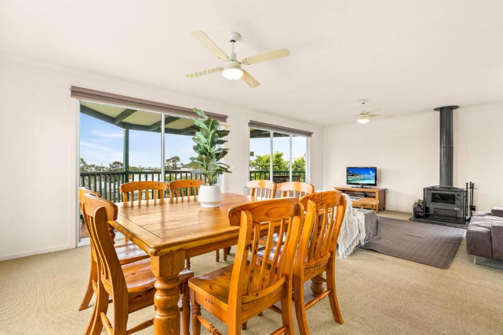 a dining room with a table and chairs at Views on Bayview in Cowes