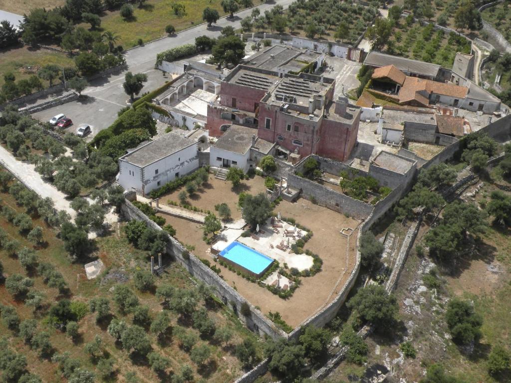 an aerial view of a house with a pool at Masseria Spina Resort in Monopoli