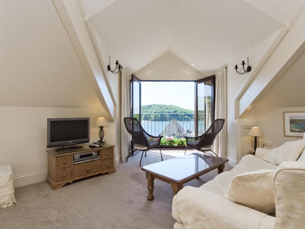 a living room with a couch and a tv at Wigwam in Salcombe