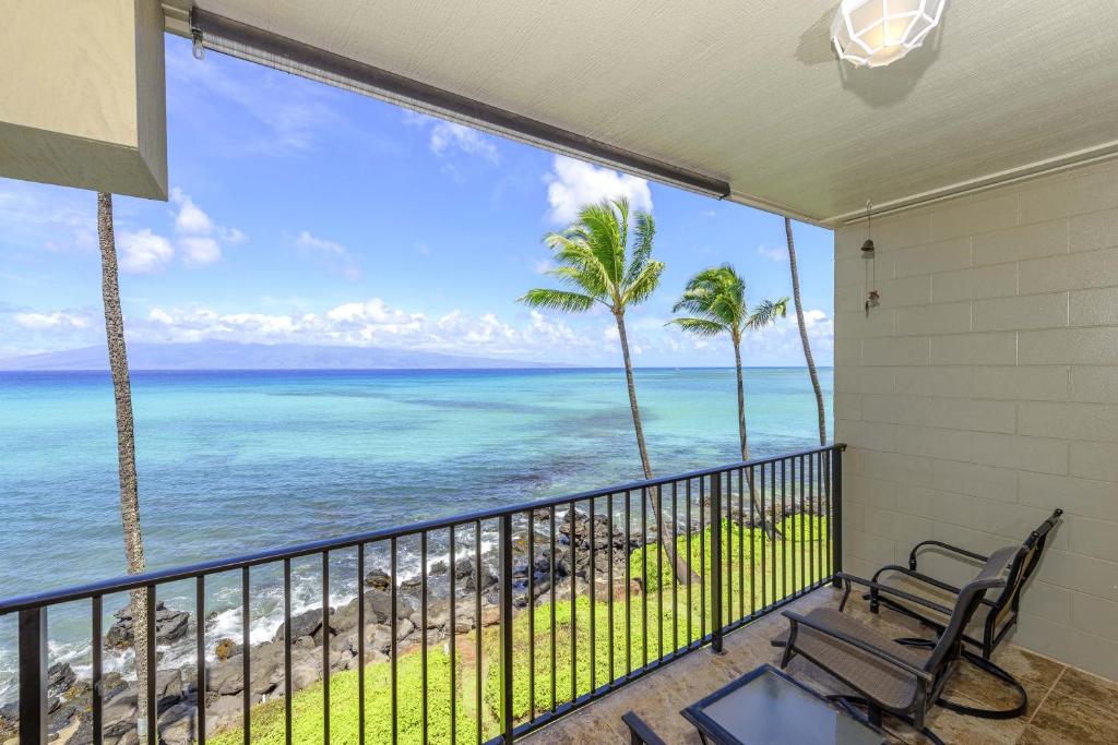 a balcony with a view of the ocean at Noelani 304 in Kahana