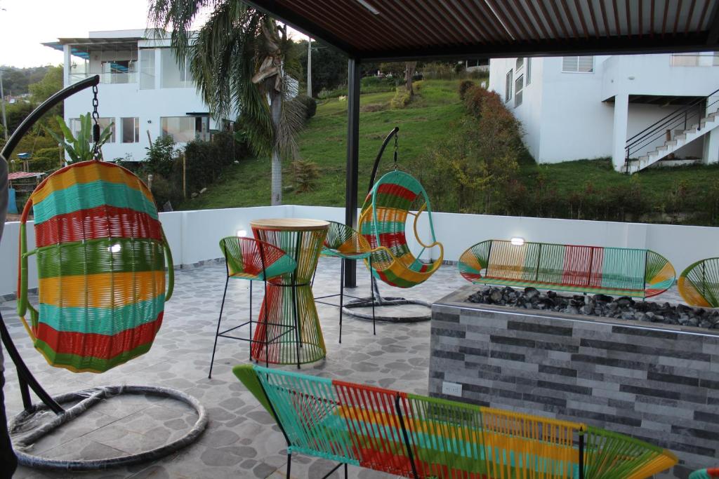 a group of chairs and tables on a patio at Nueva, Moderna casa en Silvania con Jacuzzi in Silvania