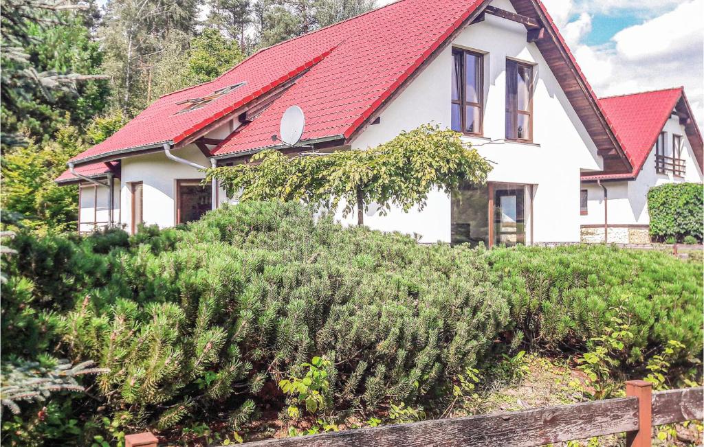 a house with a red roof and a fence at Amazing Home In Purda With 4 Bedrooms in Purda